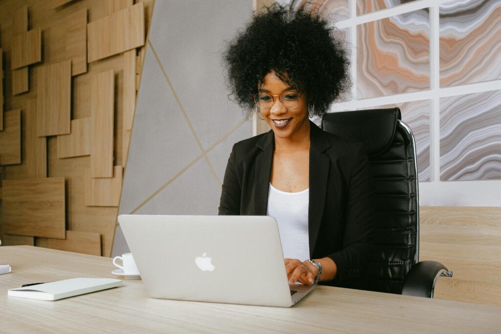 A professional woman busy working on lead qualification strategy using her laptop.