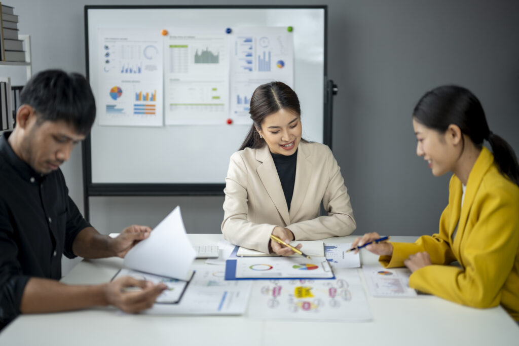 Marketing professionals collaborating on reports to improve customer lifetime value and long-term business growth.