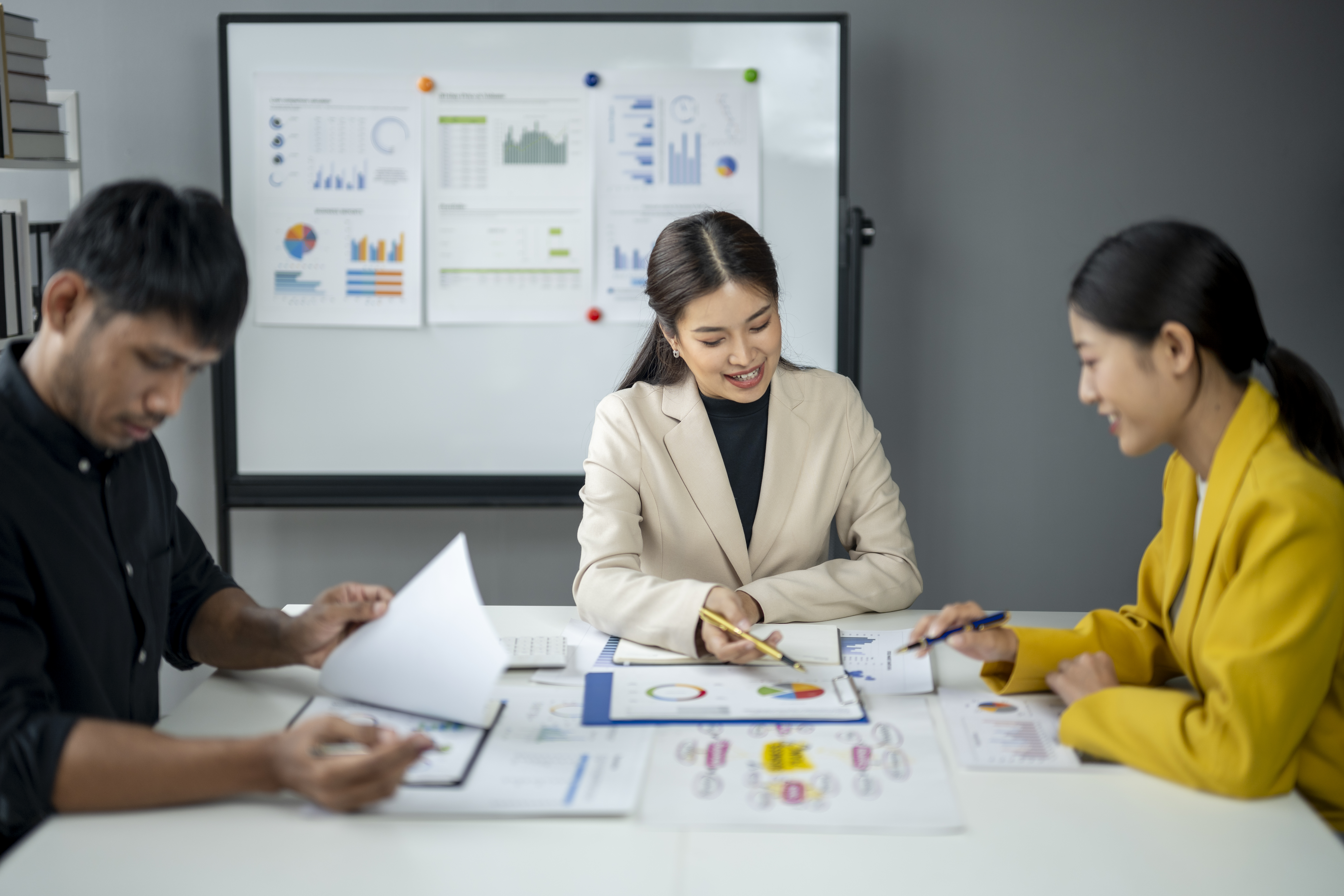 Marketing professionals collaborating on reports to improve customer lifetime value and long-term business growth.