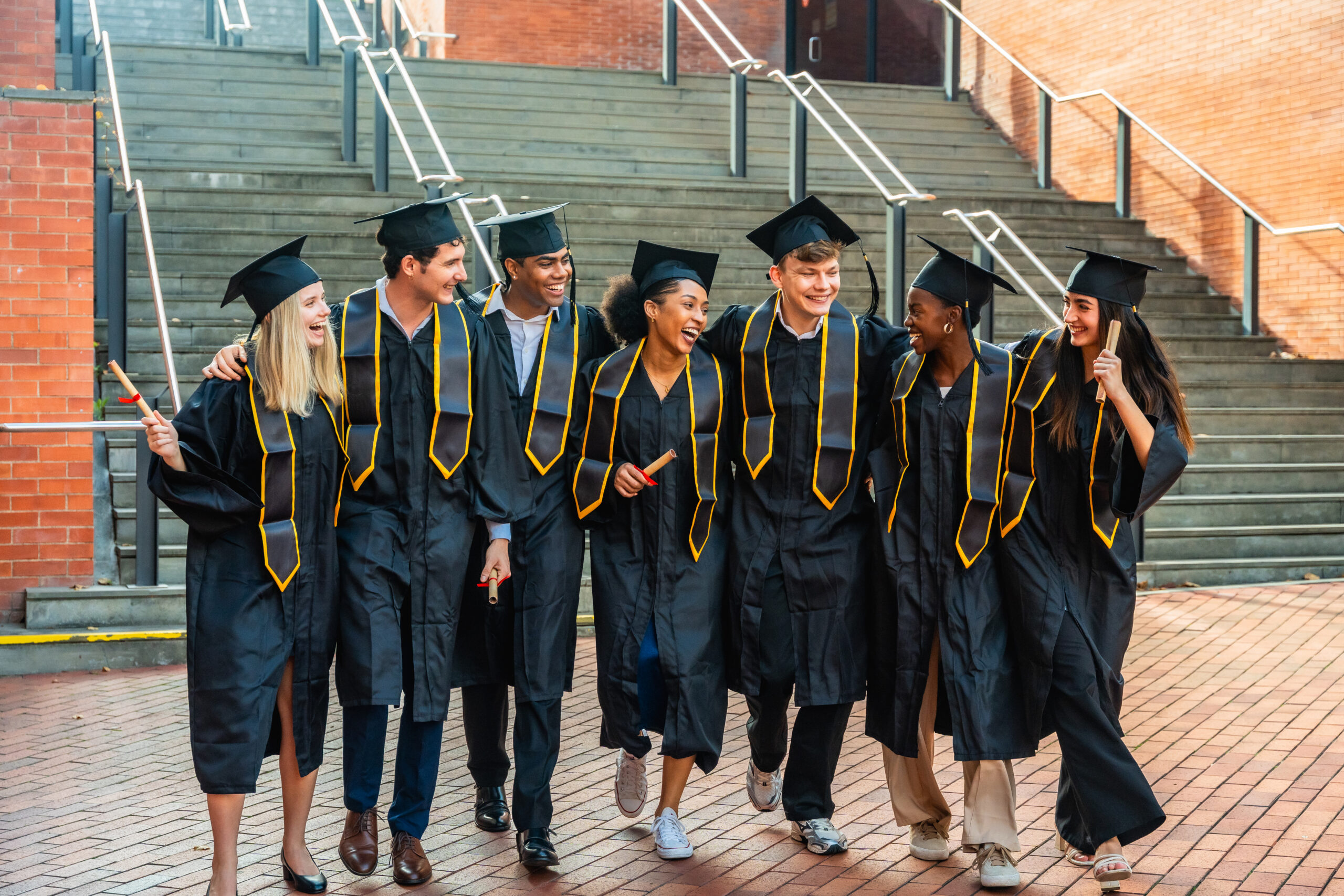 New graduates celebrating together in caps and gowns, ready to step into future opportunities.